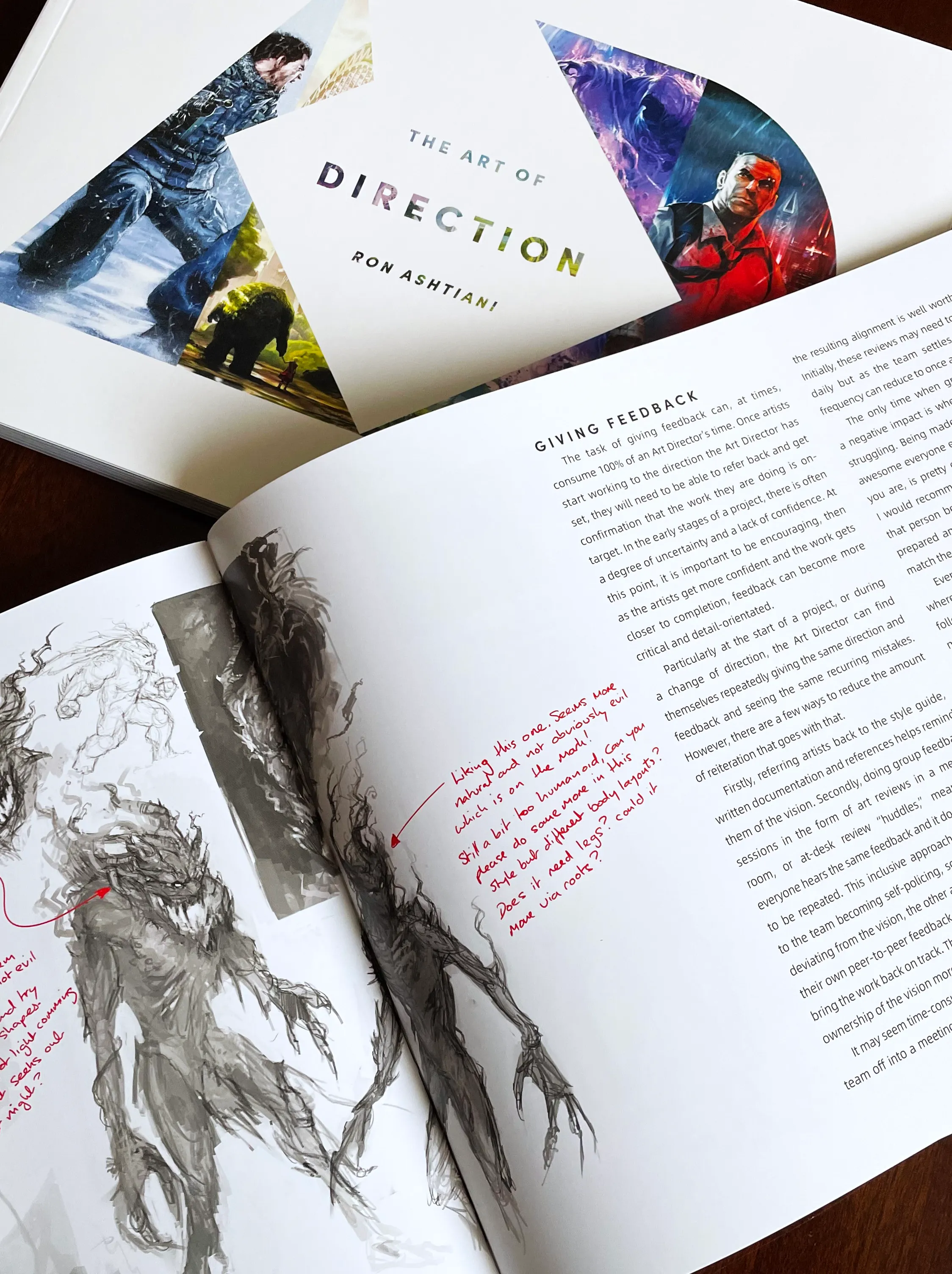 An open copy of The Art of Direction sits on top of a closed book.