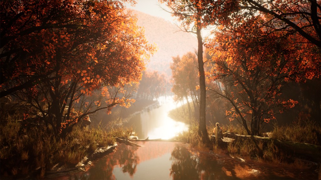 An orange fall scene, a river cutting through the middle of the frame