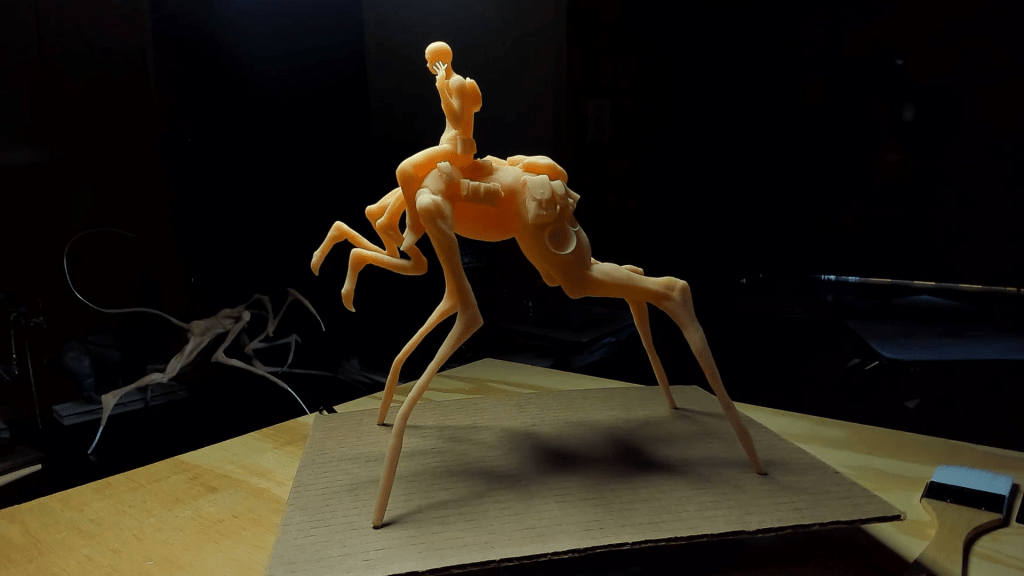 3D print of a thin alien creature with a woman sitting on top